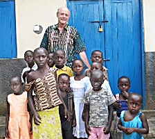Photo of Douglas Cruickshank with Uganda children by Judith Calson