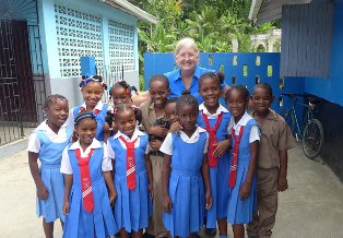 Kate Burrus with students she taught in St. Thomas Parish, Jamaica. She and her husband, John Granger, recently finished their second assignment with the Peace Corps.