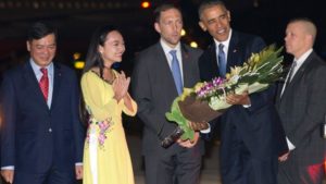 May 22, 2016: President Barack Obama is given flowers by Linh Tran, the ceremonial flower girl, as he arrives on Air Force One at Noi Bai International Airport in Hanoi, Vietnam. (AP Photo/Carolyn Kaster)